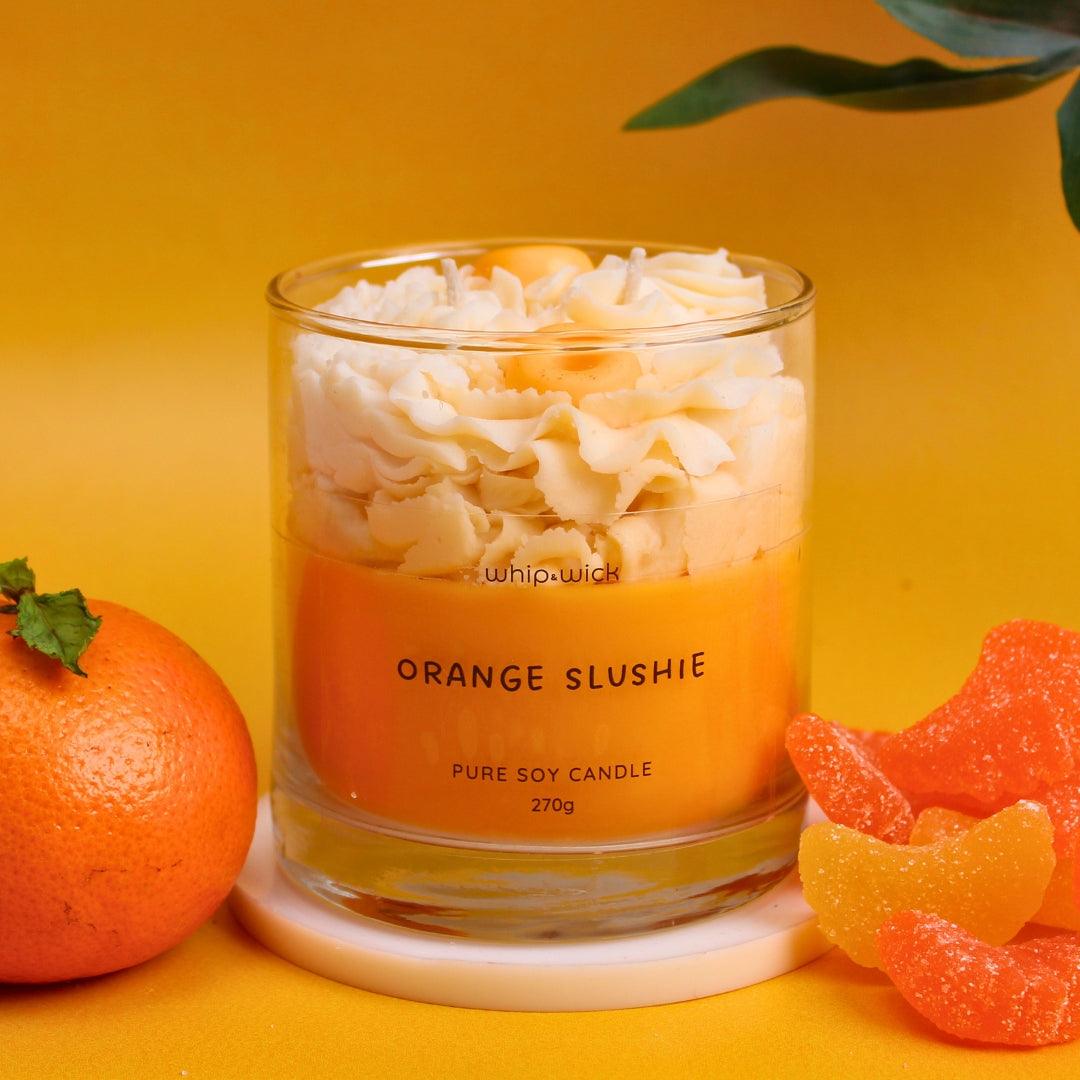 Orange Slushie Scented Candle with fresh orange, lemon, sugar, citrus, and icy notes, offering a refreshing, sweet, and cool fragrance for your space.