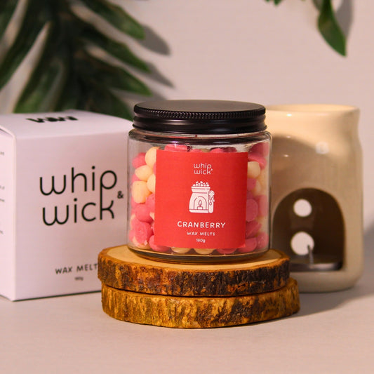 Cranberry Wax Melts with top notes of cranberries and mint, middle notes of whipped cream and sugar, and a vanilla base for a sweet, refreshing fragrance.