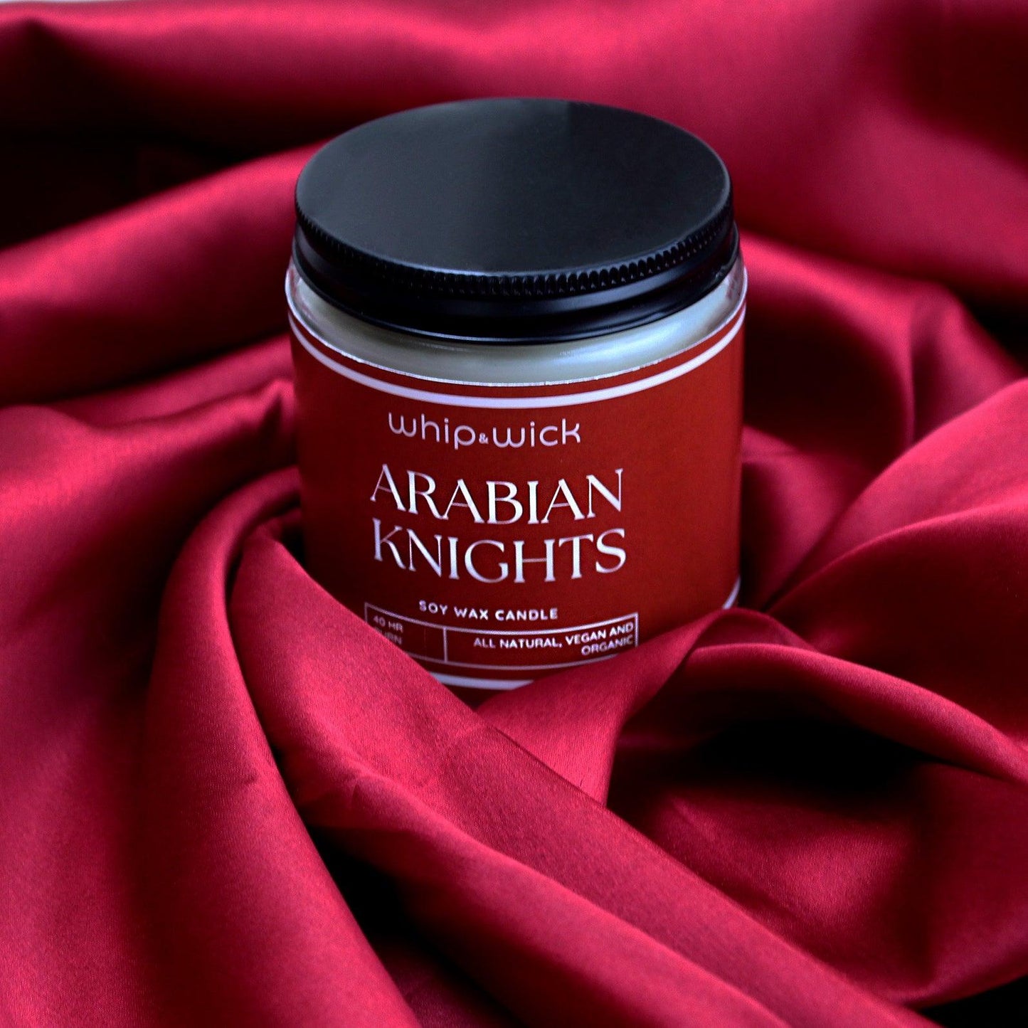 Arabian Knights Scented Candle with a rich, luxurious fragrance of roses, amberwood, and dark oud for a warm and exotic atmosphere.
