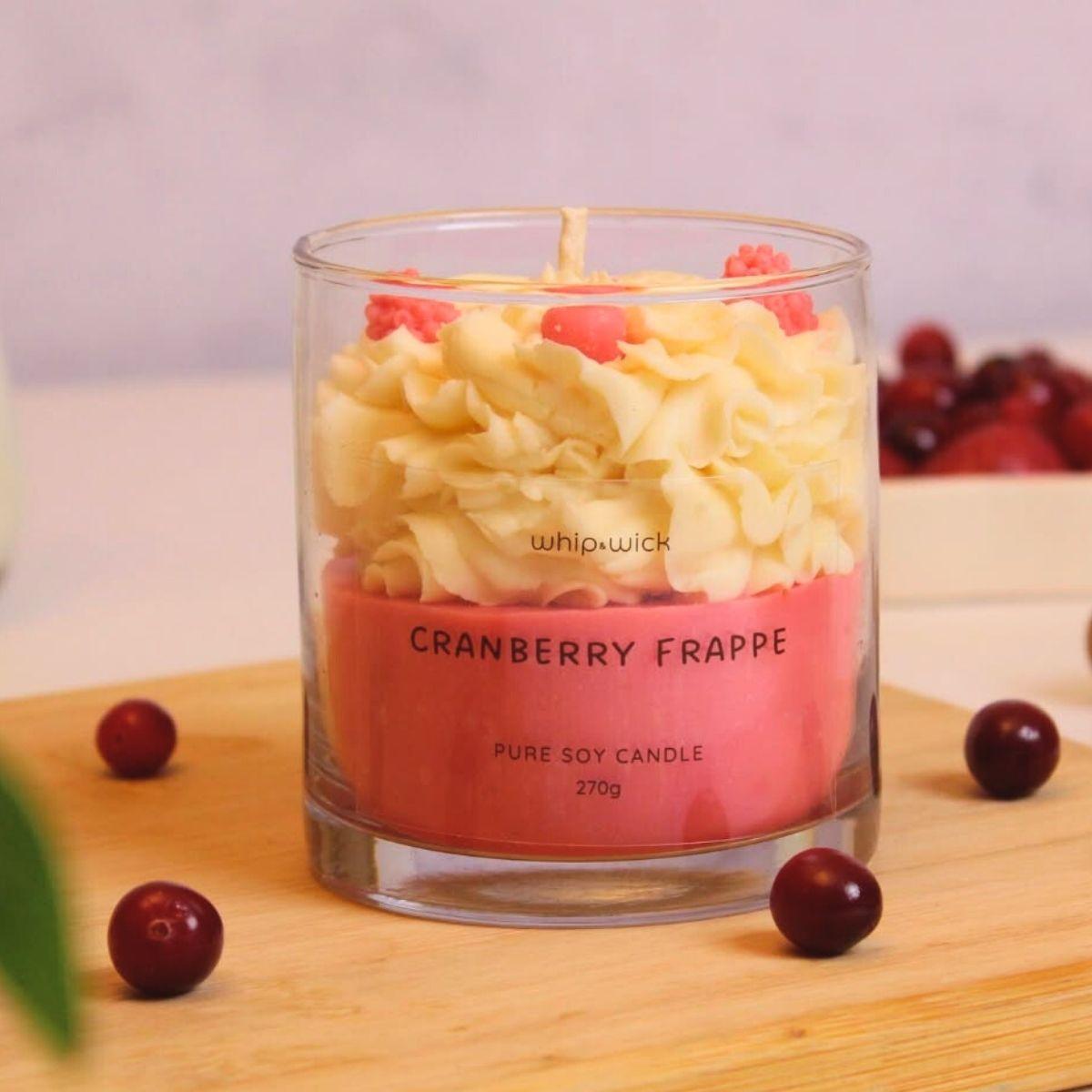 Cranberry Frappe Scented Candle with top notes of cranberries and mint, middle notes of whipped cream and sugar, and a vanilla base for a refreshing aroma.